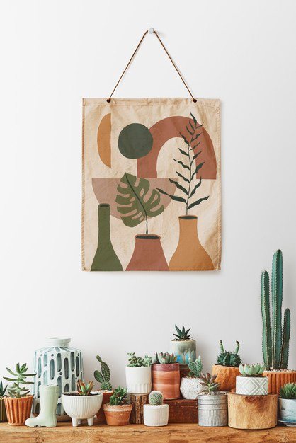 A calming wall hanging above a shelf of potted cacti and succulents